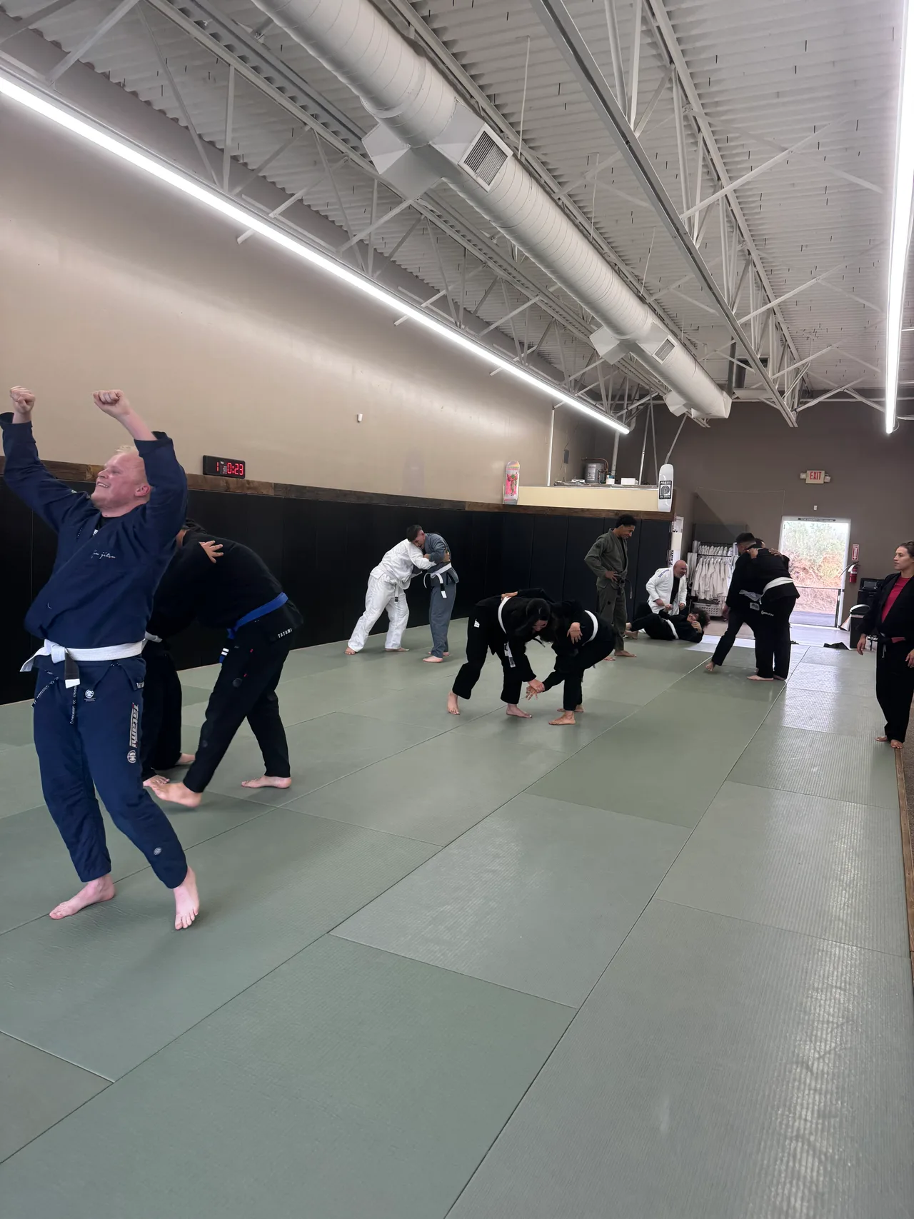 Students practicing together across the Praxis mat room