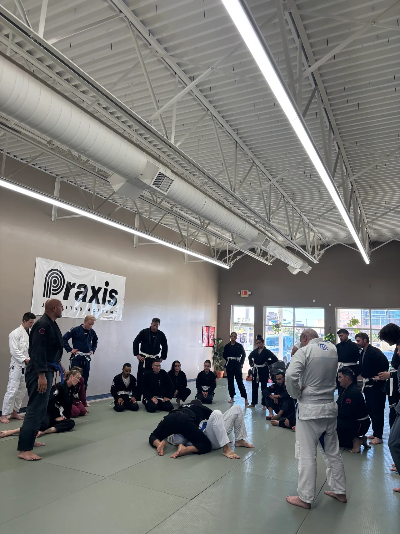 Students gathered on the mats for instruction at Praxis
