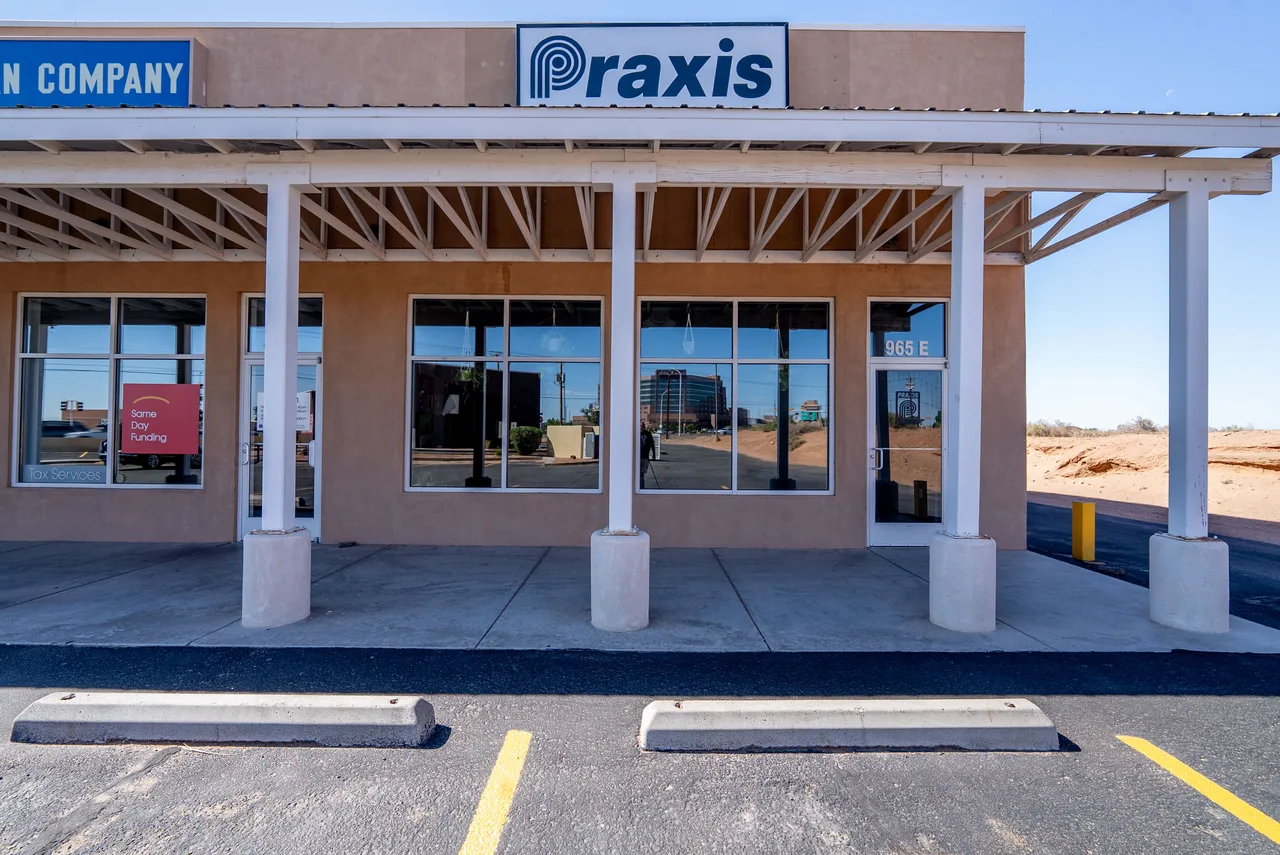 The entrance to Praxis Jiu Jitsu Academy with its sign above the door
