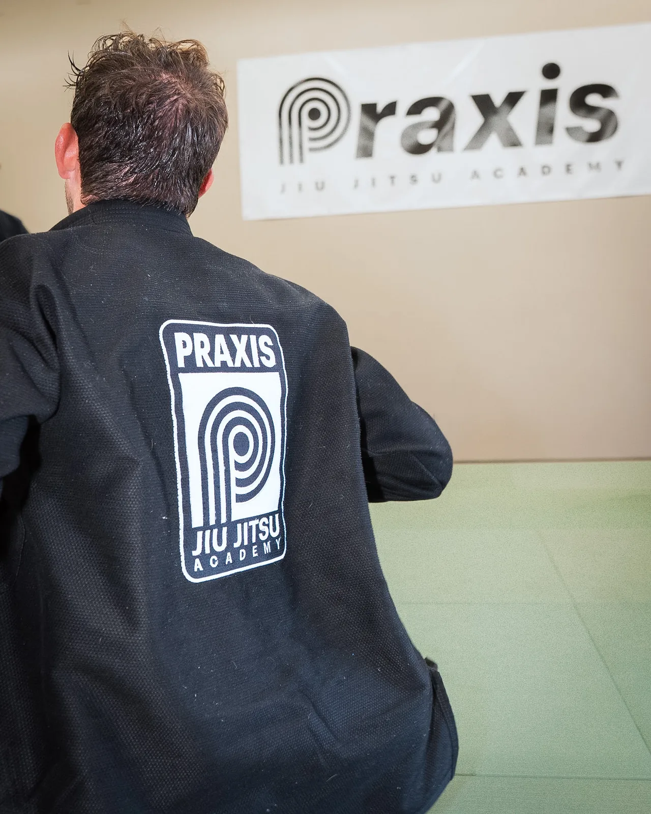 The Praxis academy patch on the back of a student’s gi
