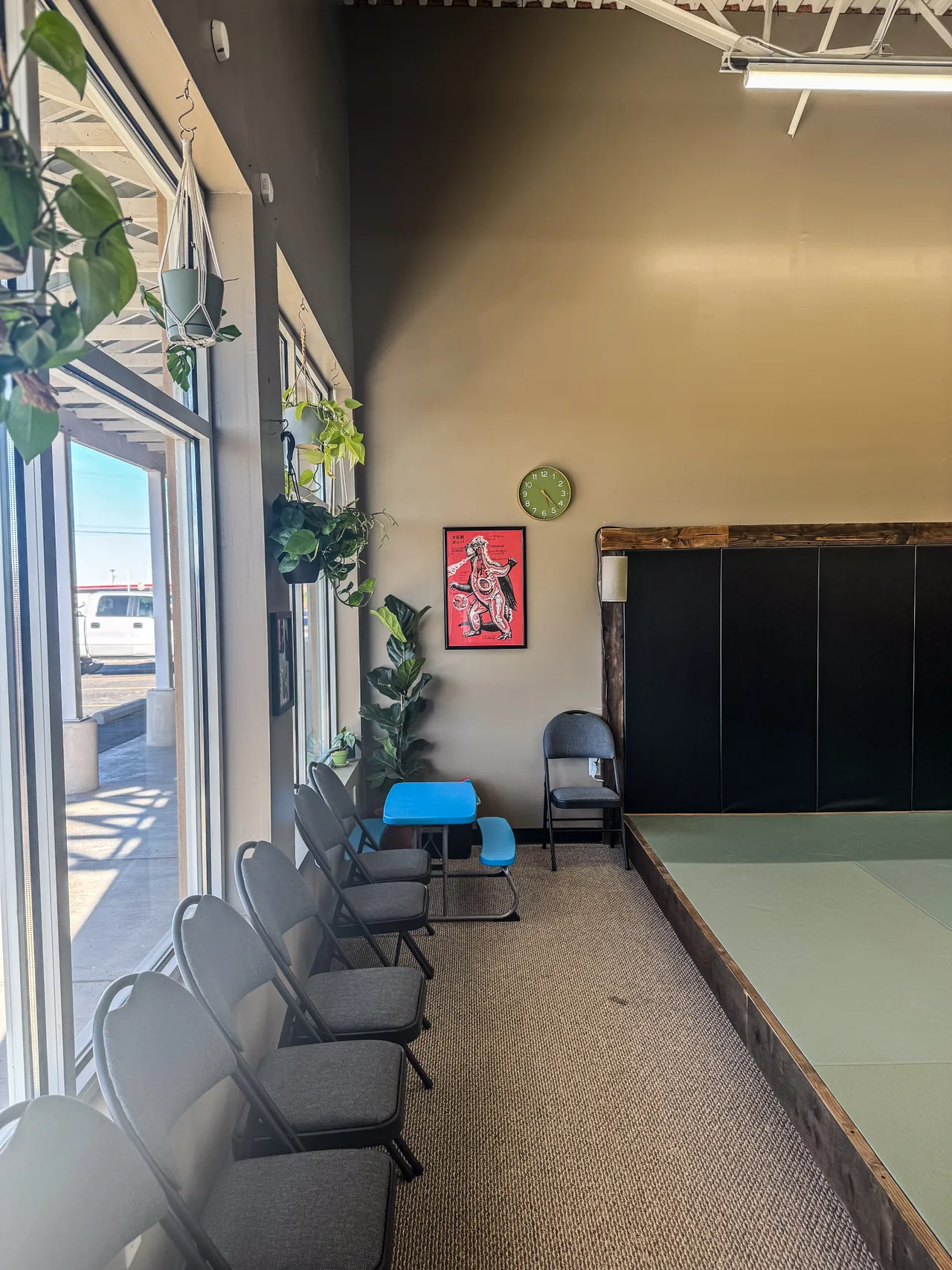 Visitor seating beside the windows and mat area at Praxis